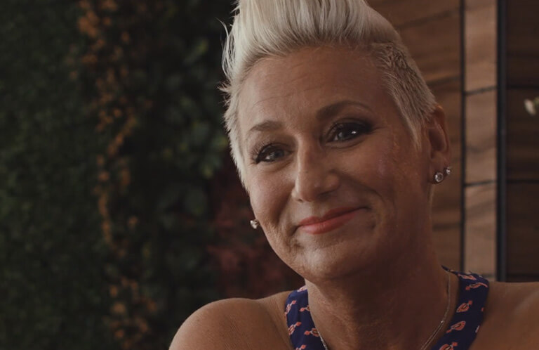 Determined and Smiling Woman, from Three Women with One Mission