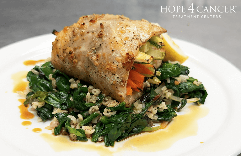 Veggie Stuffed Snapper over a bed of greens