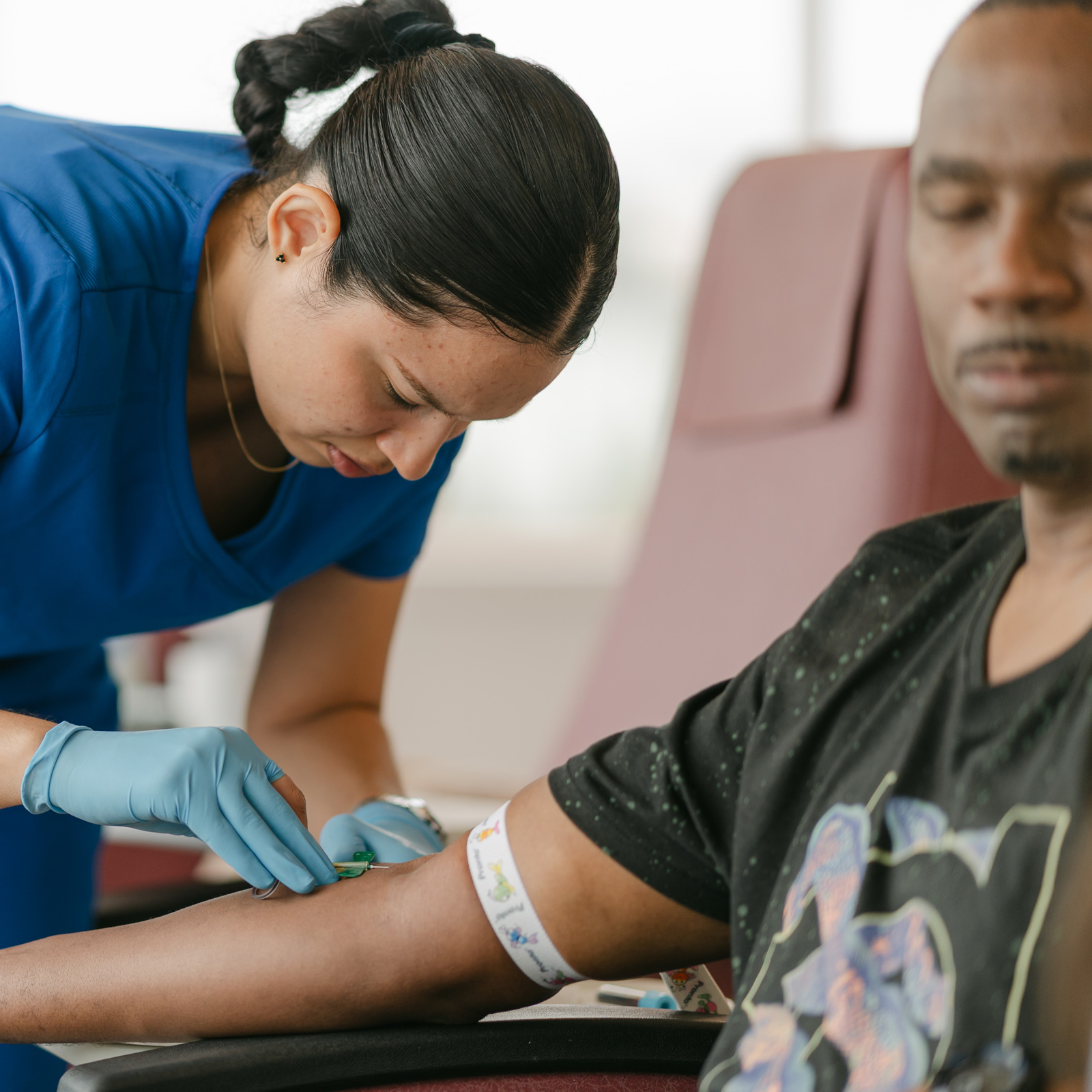 A nurse administering medicine to a patient